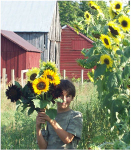 My son, Thomas, holding sunflowers picked from our farm (available through your CSA if you add the fresh-cut flowers option!).